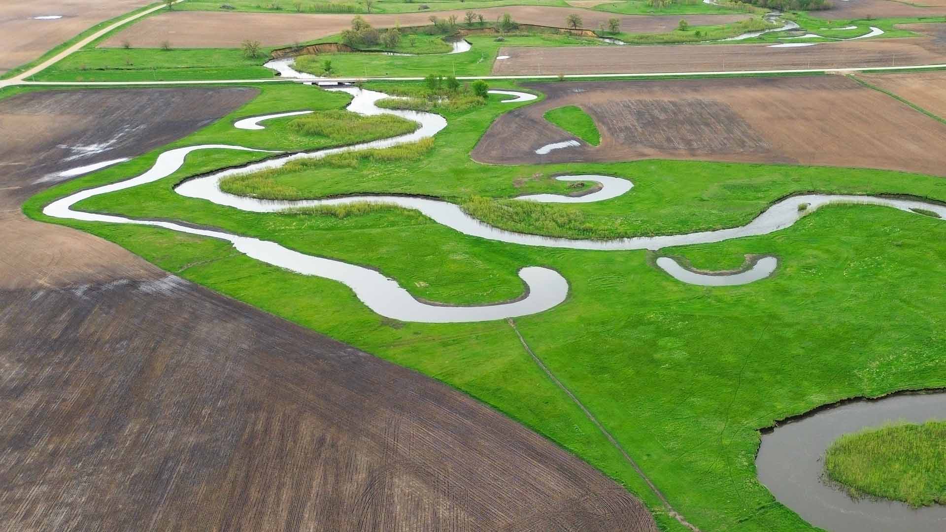 Many oxbows connected to stream in field