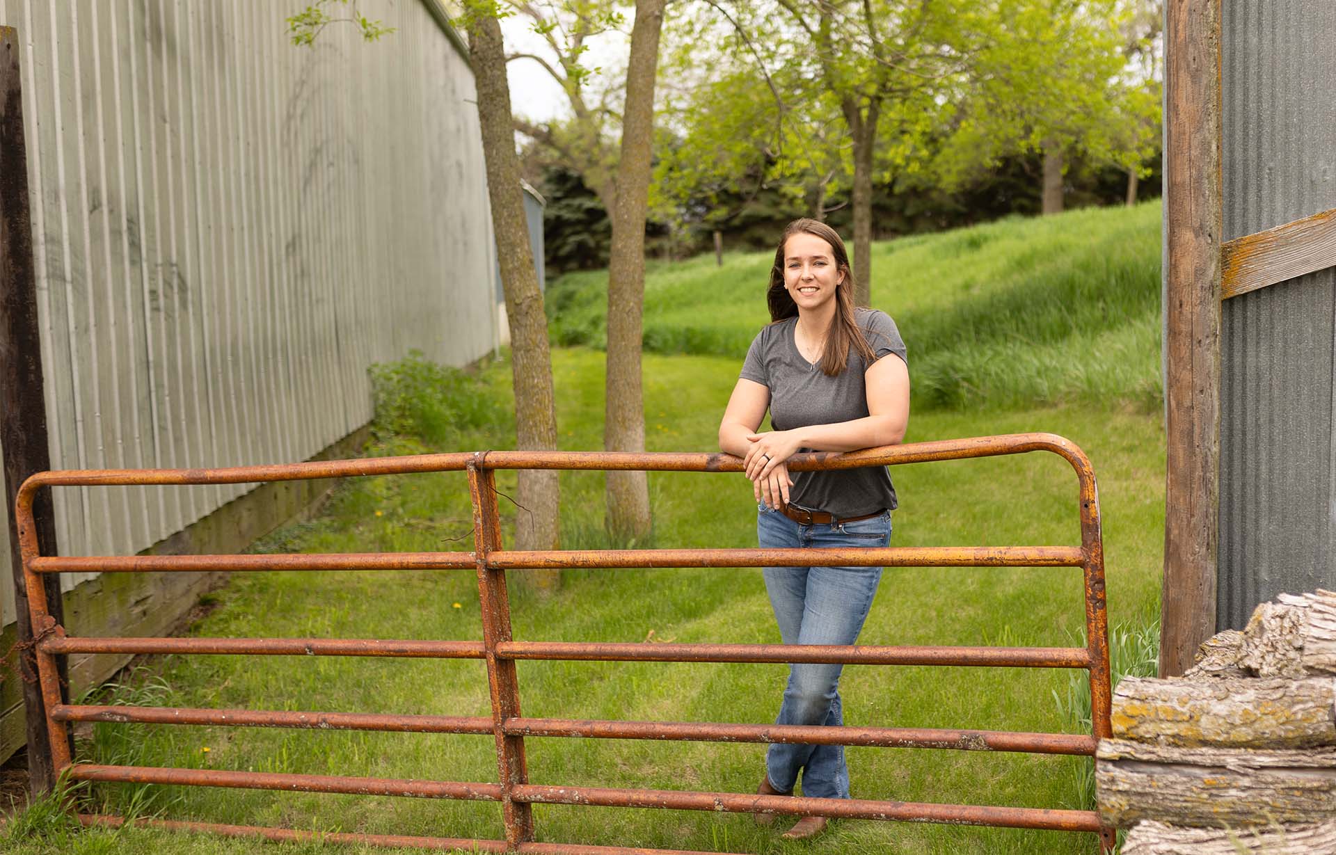 Farmer standing by fence on farm