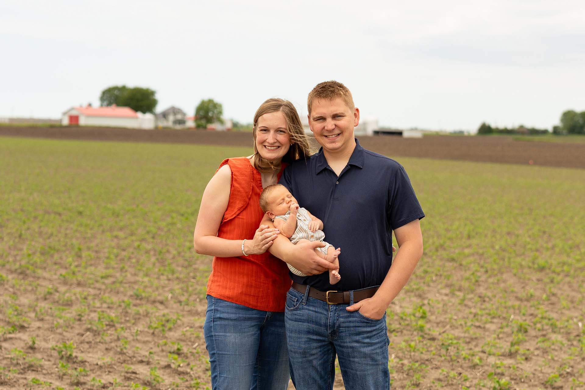 Farming couple standing in field