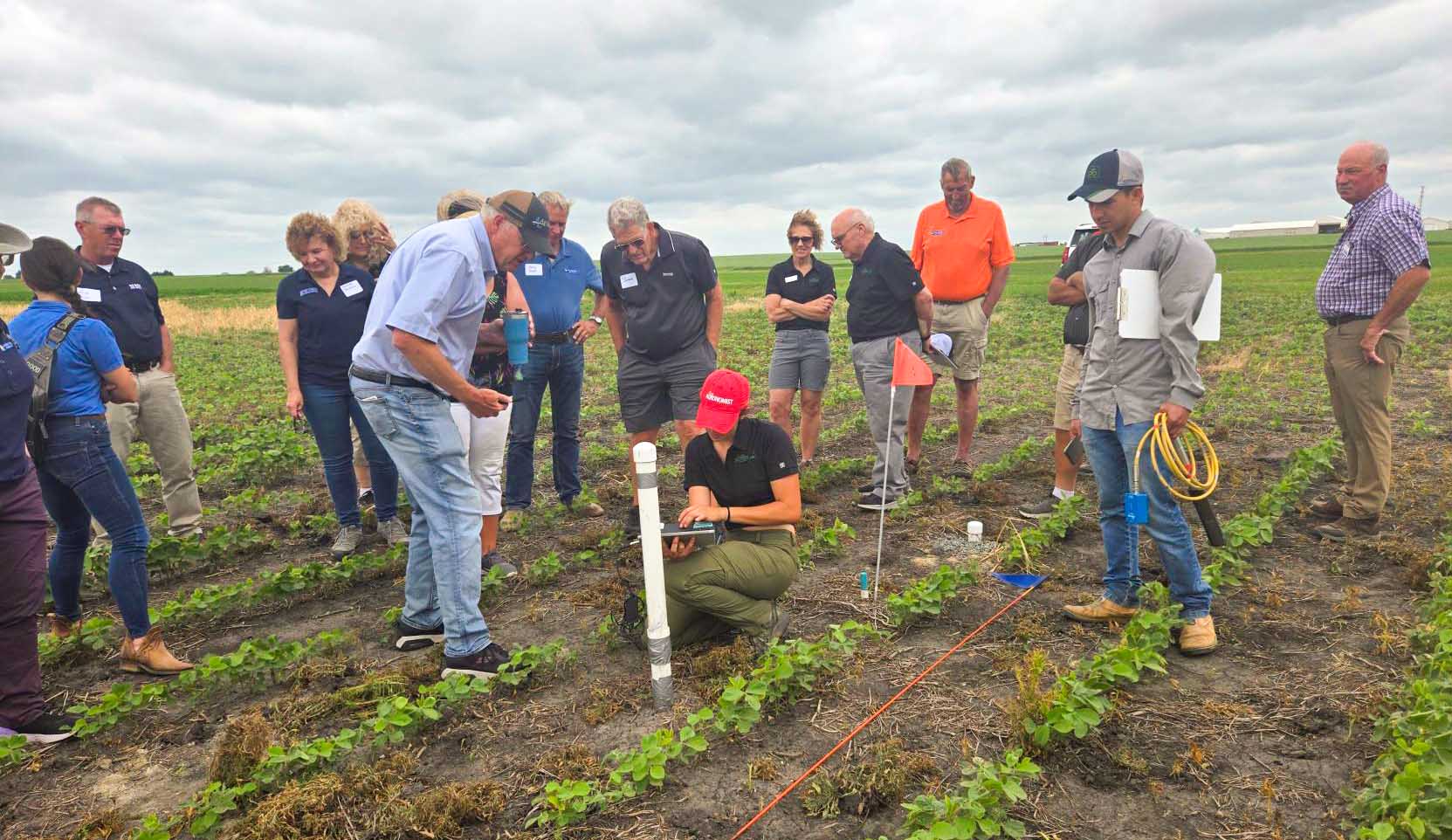 Farmers in field with ISU staff