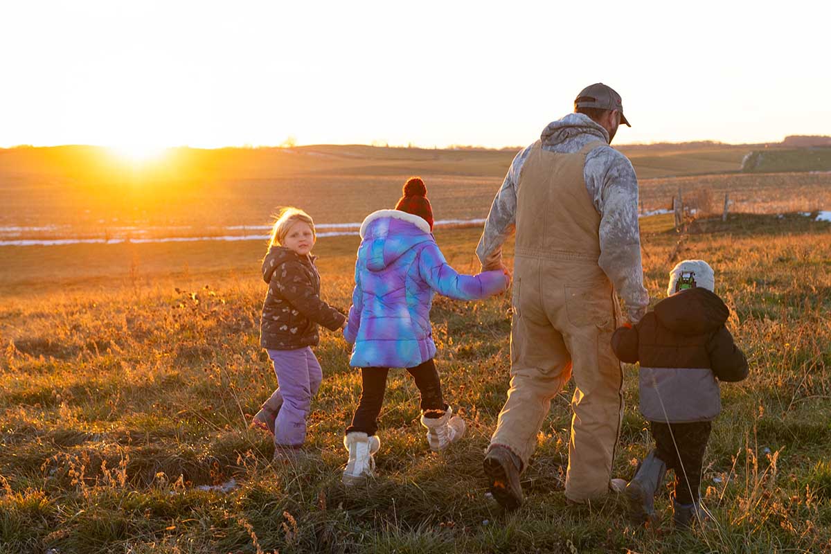 Farmer walking with kids