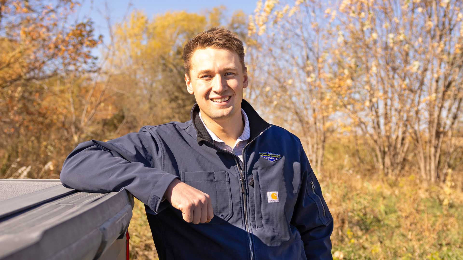 Iowa farmer leaning on truck bed