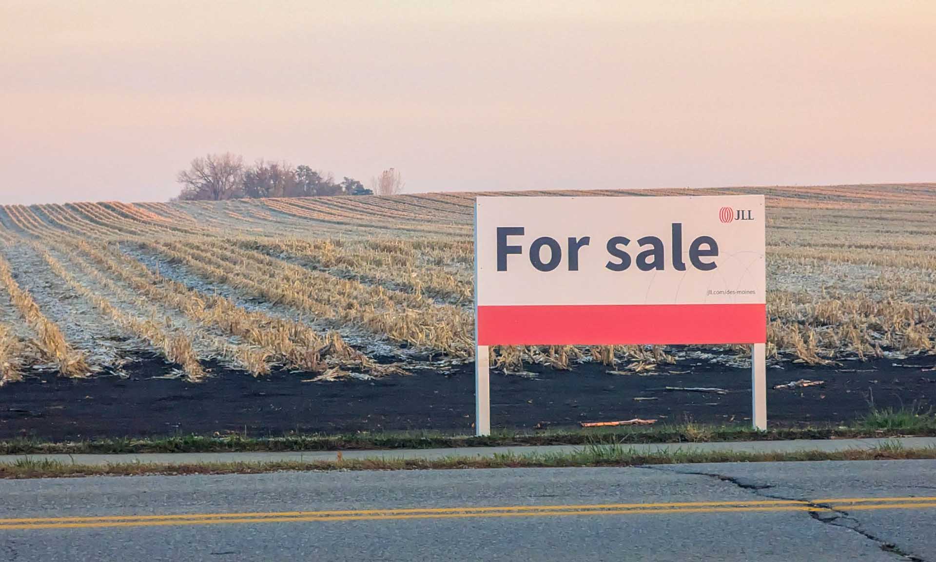 Land for sale sign in rural Iowa