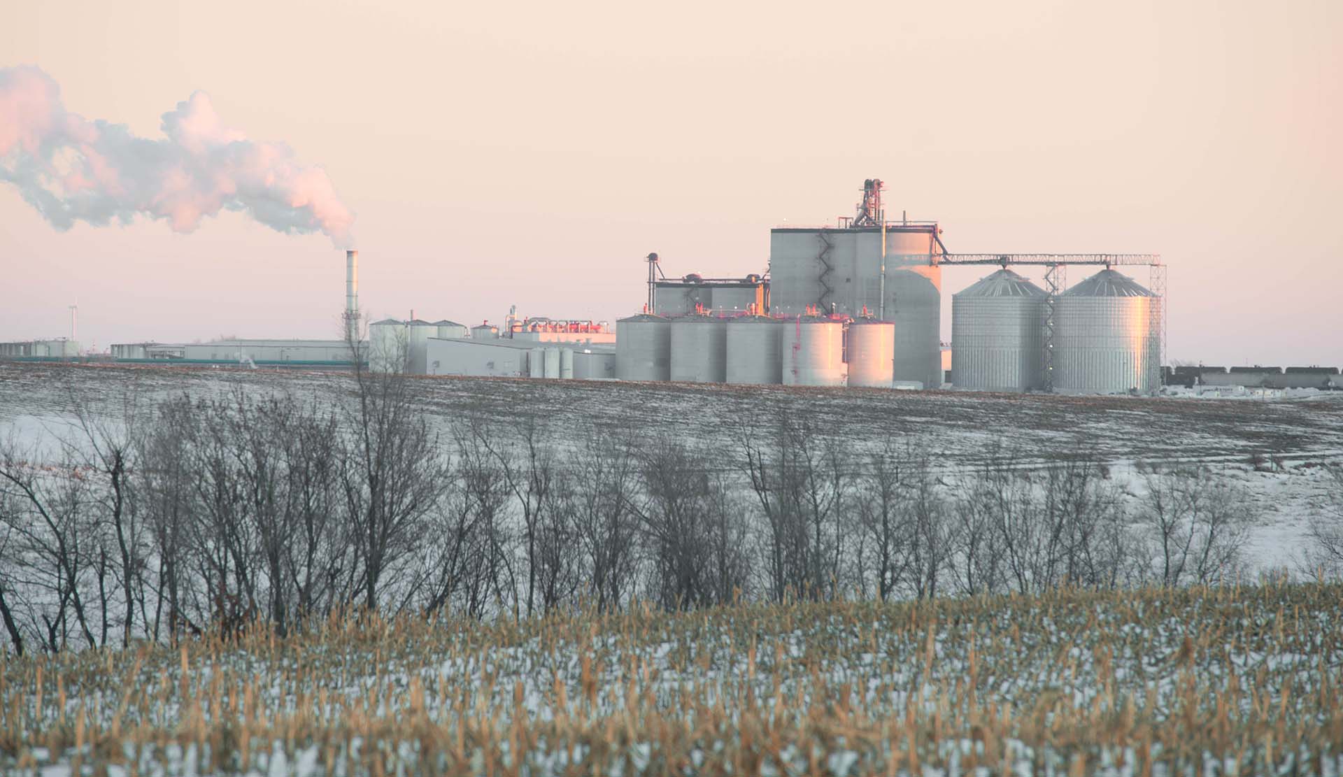 Iowa landscape photo with large biofuel facility in dis