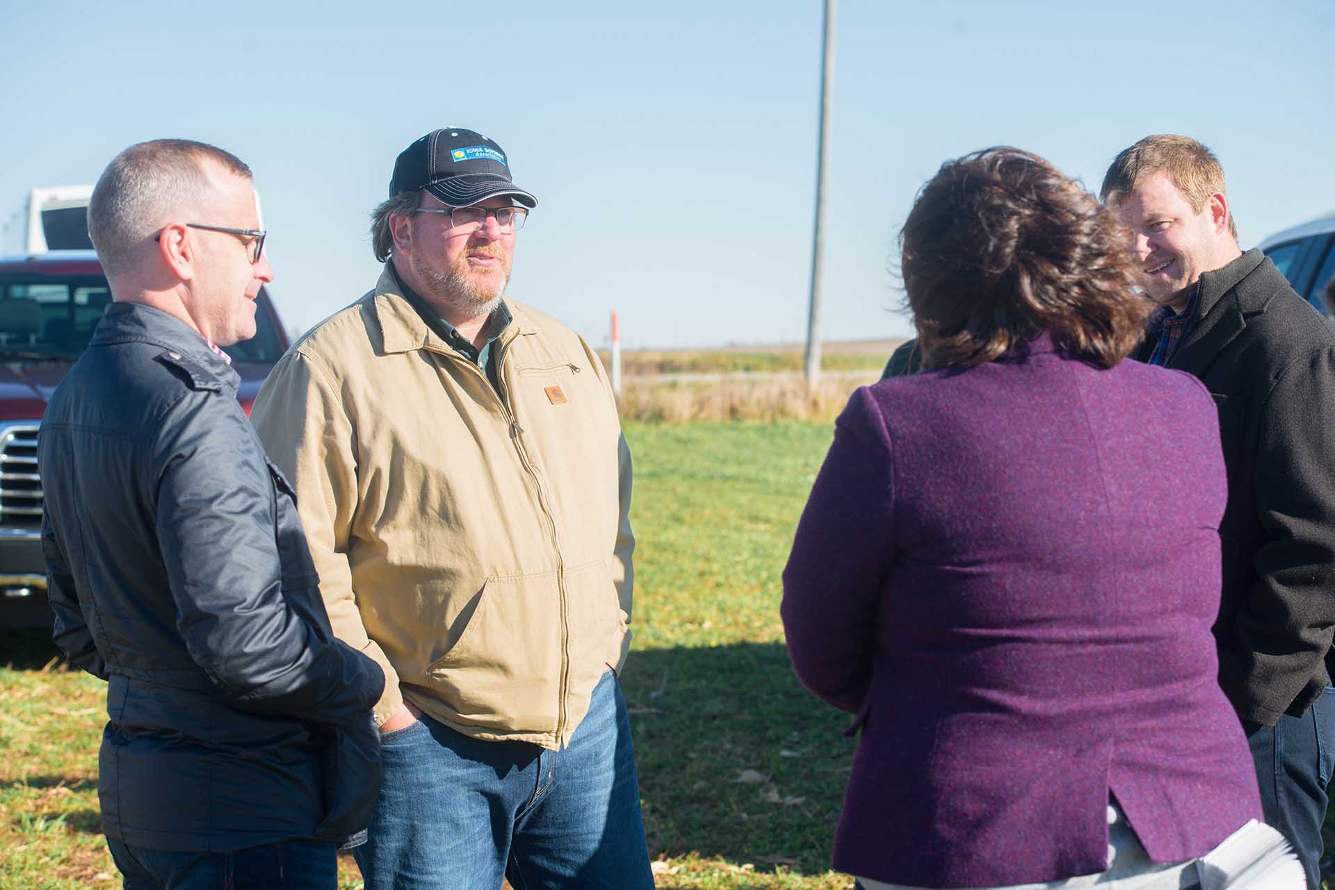 Group of individuals in field talking