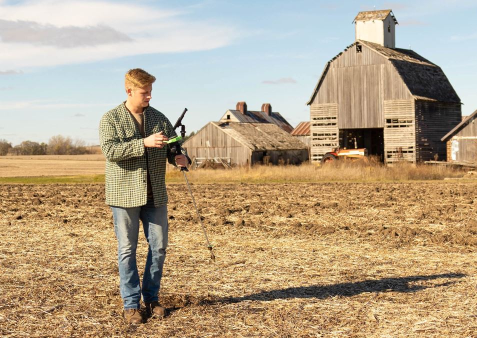 Walking in Iowa field with penetrometer