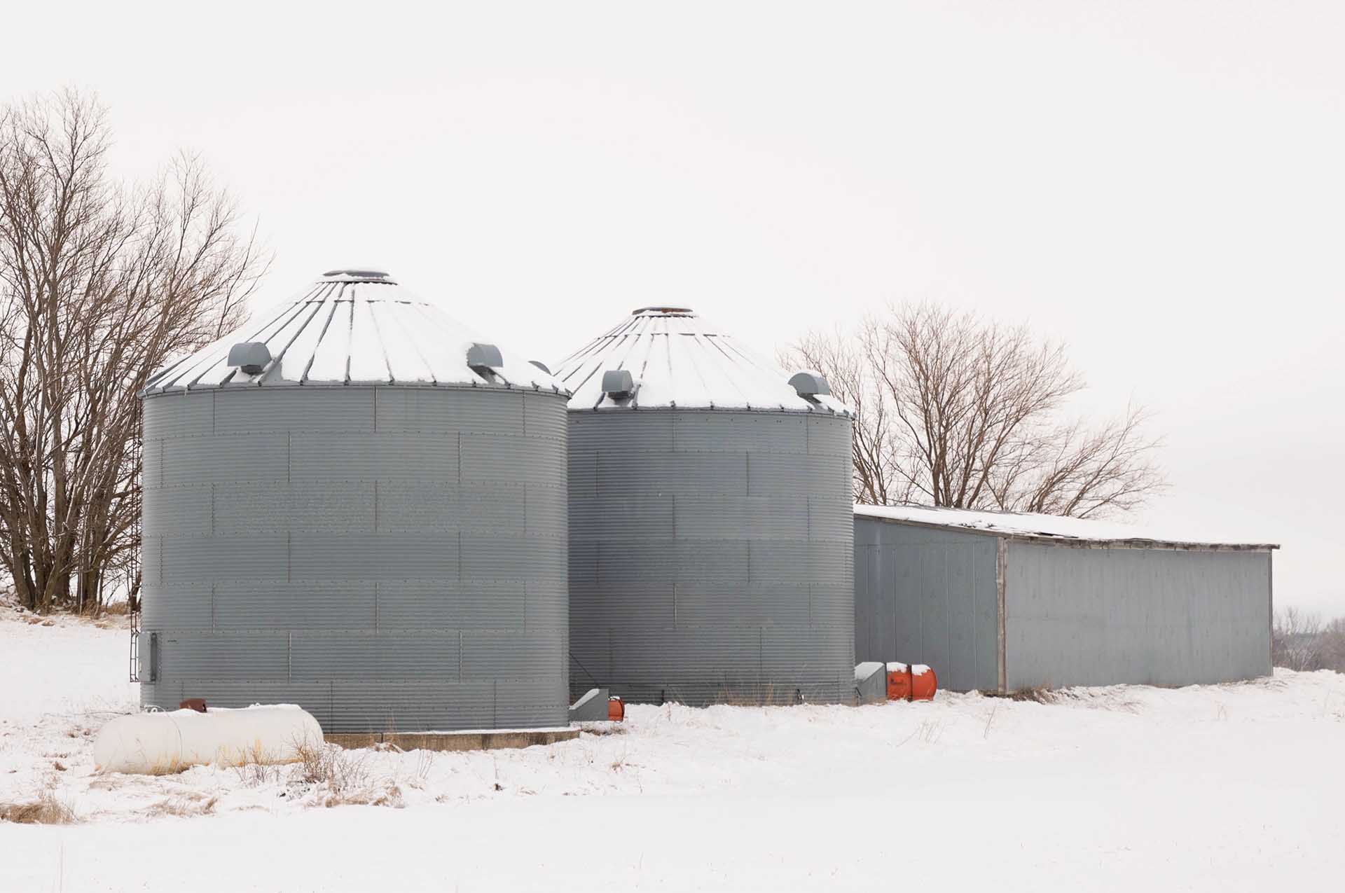 Bins on snowy landscape in Iowa