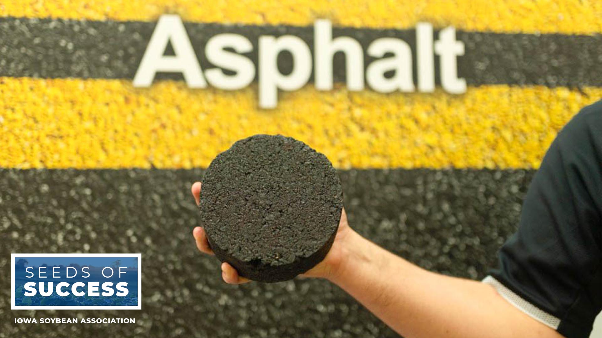 Man holding chunk of asphalt