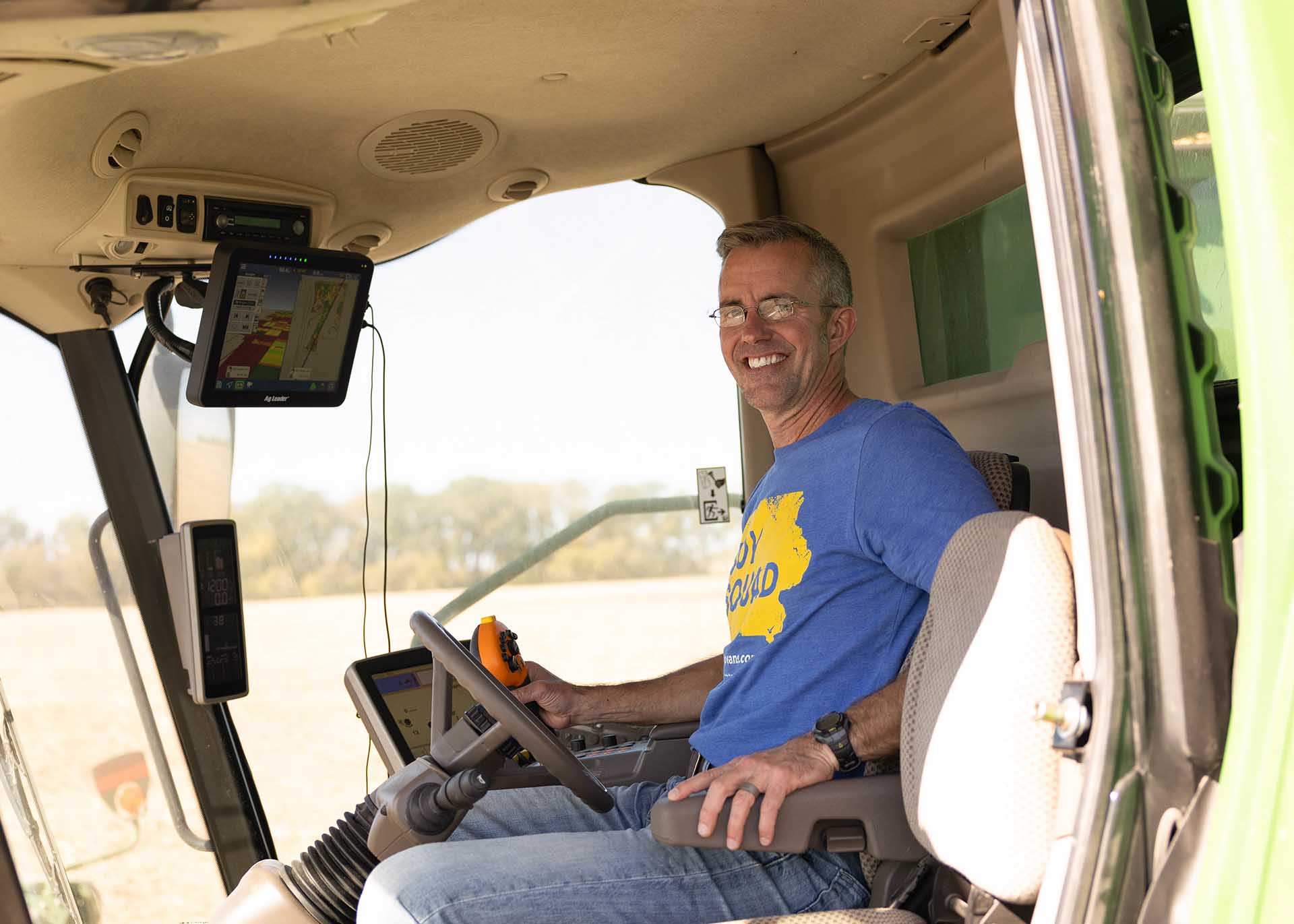 Farmer rides in a combine