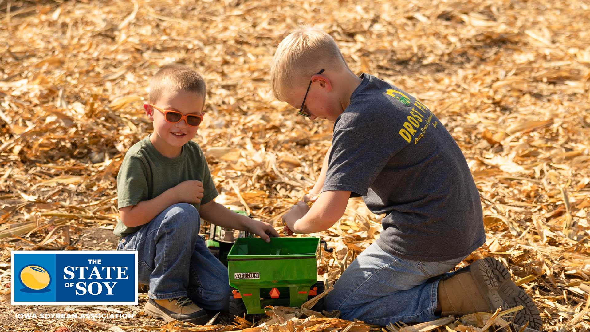 Boys playing with small tractor and wagon