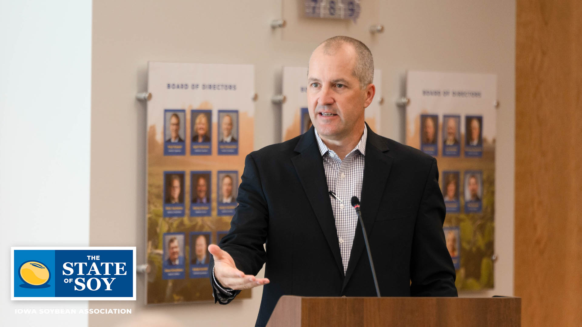 Man standing at podium speaking to group