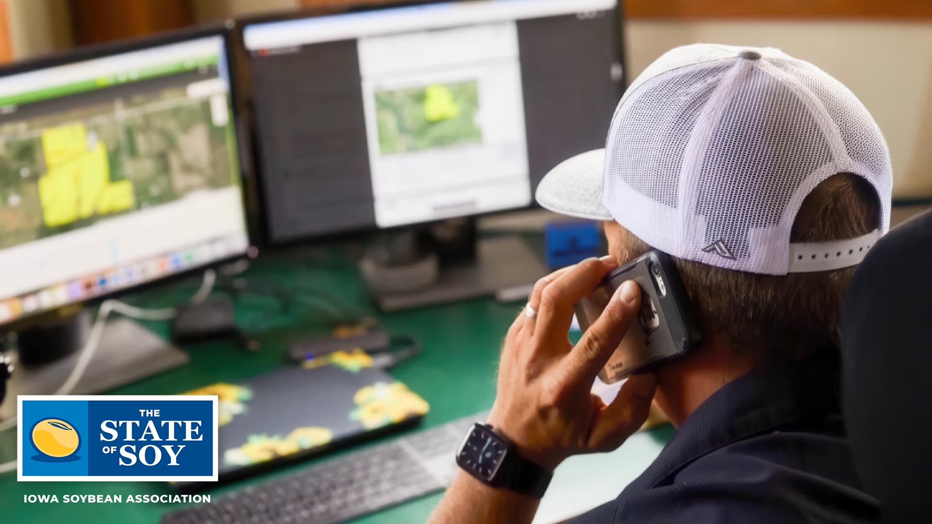 Man on phone looking at farming maps